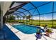 Beautiful screened-in pool and spa with a view of the golf course at 225 Pesaro Dr, North Venice, FL 34275