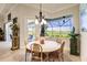 Bright dining room with a round table and view of the golf course at 225 Pesaro Dr, North Venice, FL 34275