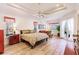 Large main bedroom with ample space, wood flooring, and access to patio at 225 Pesaro Dr, North Venice, FL 34275