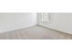 Neutral carpeted bedroom featuring a window and base trim at 12744 Wanderlust Pl, Parrish, FL 34219