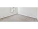 Neutral carpeted bedroom featuring a window and base trim at 12744 Wanderlust Pl, Parrish, FL 34219