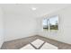 Bright bedroom with neutral carpeting and large window at 12744 Wanderlust Pl, Parrish, FL 34219