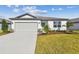 One-story home with attached garage, landscaping, and a concrete driveway at 12744 Wanderlust Pl, Parrish, FL 34219