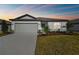 House exterior showcasing gray garage door and landscaping at 12744 Wanderlust Pl, Parrish, FL 34219