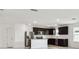 Modern kitchen with dark cabinets, island, and stainless steel appliances at 12744 Wanderlust Pl, Parrish, FL 34219
