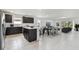 Bright, open kitchen featuring dark cabinetry, a center island, and stainless steel appliances at 12744 Wanderlust Pl, Parrish, FL 34219