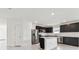 Modern kitchen featuring dark cabinets, stainless steel appliances, and an island at 12744 Wanderlust Pl, Parrish, FL 34219