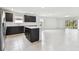 Open floor plan with a kitchen island, stainless steel appliances, and a view of the living room at 12744 Wanderlust Pl, Parrish, FL 34219