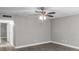 Living room with ceiling fan and access to hallway at 11702 Raintree Village Blvd # A, Temple Terrace, FL 33617