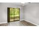 Simple bedroom with sliding glass doors and access to patio at 11702 Raintree Village Blvd # A, Temple Terrace, FL 33617