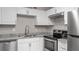 Newly renovated kitchen with granite countertops and stainless steel appliances at 11702 Raintree Village Blvd # A, Temple Terrace, FL 33617