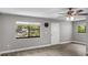 Bright living room with wood-look floors and ceiling fan at 11702 Raintree Village Blvd # A, Temple Terrace, FL 33617