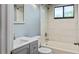 Updated bathroom with gray vanity, white toilet and bathtub, and light blue walls at 11702 Raintree Village Blvd # A, Temple Terrace, FL 33617