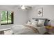 Cozy bedroom with large window and ceiling fan at 11702 Raintree Village Blvd # A, Temple Terrace, FL 33617