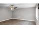 Living room with ceiling fan and wood-look floors at 11702 Raintree Village Blvd # A, Temple Terrace, FL 33617