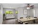 Dining area with staged table and chairs at 11702 Raintree Village Blvd # A, Temple Terrace, FL 33617