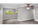 Spacious living room with ceiling fan and large window at 11702 Raintree Village Blvd # A, Temple Terrace, FL 33617