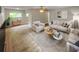 Living room with staged furniture and large window at 11702 Raintree Village Blvd # A, Temple Terrace, FL 33617