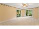 Bright bedroom with a ceiling fan, carpet, and sliding glass doors at 2925 W Sligh Ave, Tampa, FL 33614