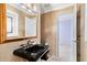 Elegant powder room with a black pedestal sink and gold accents at 2925 W Sligh Ave, Tampa, FL 33614