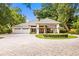 Elegant home exterior with circular driveway and fountain at 2925 W Sligh Ave, Tampa, FL 33614