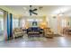 Living room with hardwood floors, seating, and access to patio at 1940 Inverness Greens Dr # 1940, Sun City Center, FL 33573