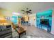 Open concept living room with hardwood floors and a view into the kitchen and dining area at 1940 Inverness Greens Dr # 1940, Sun City Center, FL 33573