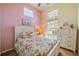 Charming bedroom with a floral comforter and a dresser at 1940 Inverness Greens Dr # 1940, Sun City Center, FL 33573