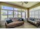 Relaxing sunroom with wicker furniture and golf course views at 1940 Inverness Greens Dr # 1940, Sun City Center, FL 33573