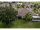 Aerial view of house showcasing backyard, landscaping, and a screened enclosure at 1940 Inverness Greens Dr # 1940, Sun City Center, FL 33573
