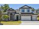 Charming two-story home featuring stone accents, a two-car garage, and a well-manicured lawn at 149 Hidden Estates Ct, Brandon, FL 33511