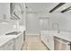 Modern kitchen with white cabinets, quartz countertops, and stainless steel appliances at 149 Hidden Estates Ct, Brandon, FL 33511