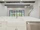 Modern kitchen features a farmhouse sink, quartz countertops, and stainless steel appliances at 149 Hidden Estates Ct, Brandon, FL 33511
