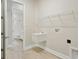 Laundry room with utility sink and overhead shelving at 149 Hidden Estates Ct, Brandon, FL 33511