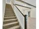 Elegant staircase with dark wood handrail and neutral carpeting at 149 Hidden Estates Ct, Brandon, FL 33511