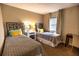 Comfortable bedroom featuring twin beds with stylish headboards, neutral colors and natural light at 6504 Abaco Dr # 101, Apollo Beach, FL 33572