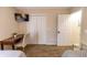Bedroom with a desk, closet space, and an open door, providing a functional and cozy area at 6504 Abaco Dr # 101, Apollo Beach, FL 33572