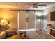 Charming living room featuring sliding barn doors, ceiling fan, and comfortable seating for a relaxing ambiance at 6504 Abaco Dr # 101, Apollo Beach, FL 33572