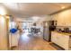 Open concept kitchen with granite countertops and stainless steel appliances at 6504 Abaco Dr # 101, Apollo Beach, FL 33572