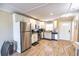 Modern kitchen with stainless steel appliances and light wood cabinets at 6504 Abaco Dr # 101, Apollo Beach, FL 33572
