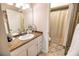 Bathroom with granite countertop, white cabinets, and shower/tub combo at 6504 Abaco Dr # 101, Apollo Beach, FL 33572