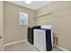 Functional laundry room with washer, dryer and shelving at 17516 Queensland St, Land O Lakes, FL 34638