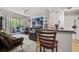 Living room with sectional sofa, access to balcony, and large artwork at 17104 Carrington Park Dr # 528, Tampa, FL 33647