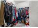 Full-size closet with clothing, shoes, and storage boxes at 17104 Carrington Park Dr # 528, Tampa, FL 33647