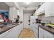 Kitchen with white cabinets, granite countertops, and appliances at 17104 Carrington Park Dr # 528, Tampa, FL 33647
