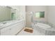 Bathroom with double vanity, soaking tub, and shower at 18940 Emerald Ridge Dr, Hudson, FL 34667