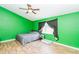 Bright bedroom with green walls and laminate wood flooring at 18940 Emerald Ridge Dr, Hudson, FL 34667
