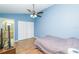 Bedroom with double bed, wood floors, and ceiling fan at 18940 Emerald Ridge Dr, Hudson, FL 34667