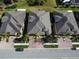 Aerial view of three villas with paved driveways and landscaping at 682 Chipper Dr, Sun City Center, FL 33573