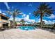 Resort-style pool with lounge chairs and palm trees at 682 Chipper Dr, Sun City Center, FL 33573